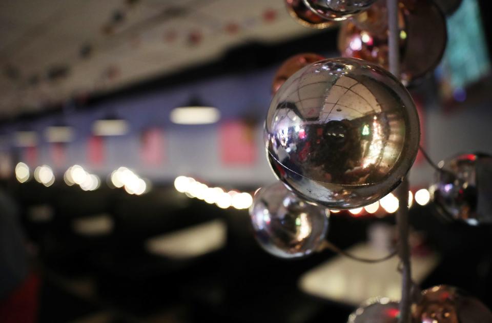 An ornament reflects the decorations at The President's Lounge, which has been transformed into the Christmas pop-up bar The Reindeer Room  in Akron.