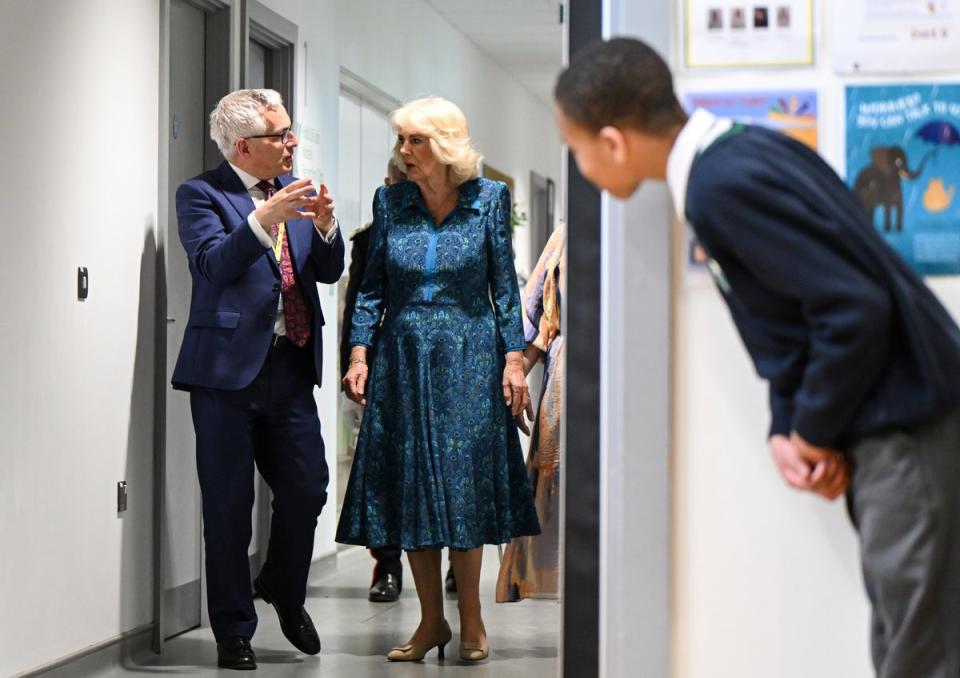 A pupil takes a peak as he waits for Queen Camilla (Justin Tallis/PA Wire)