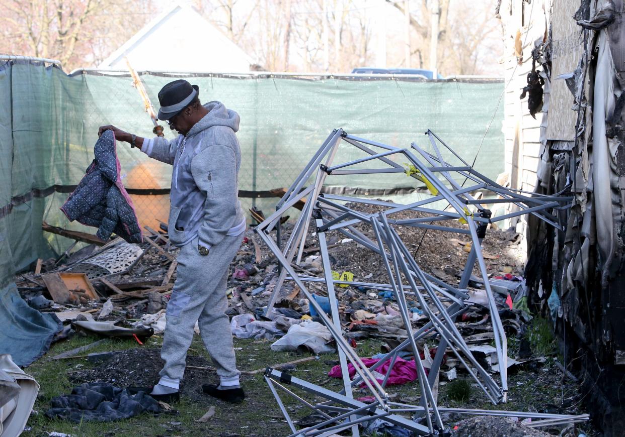 David Smith looks at a coat that was on the ground Friday, March 29, 2024, at 222 N. LaPorte Ave. at the site of a house fire on Jan. 21 that resulted in the deaths of six of his children.