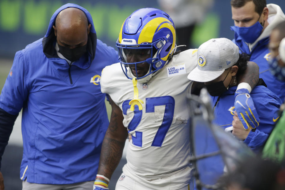 Los Angeles Rams running back Darrell Henderson Jr. (27) leaves the field with an injury during the second half of an NFL football game against the Seattle Seahawks, Sunday, Dec. 27, 2020, in Seattle. (AP Photo/Scott Eklund)