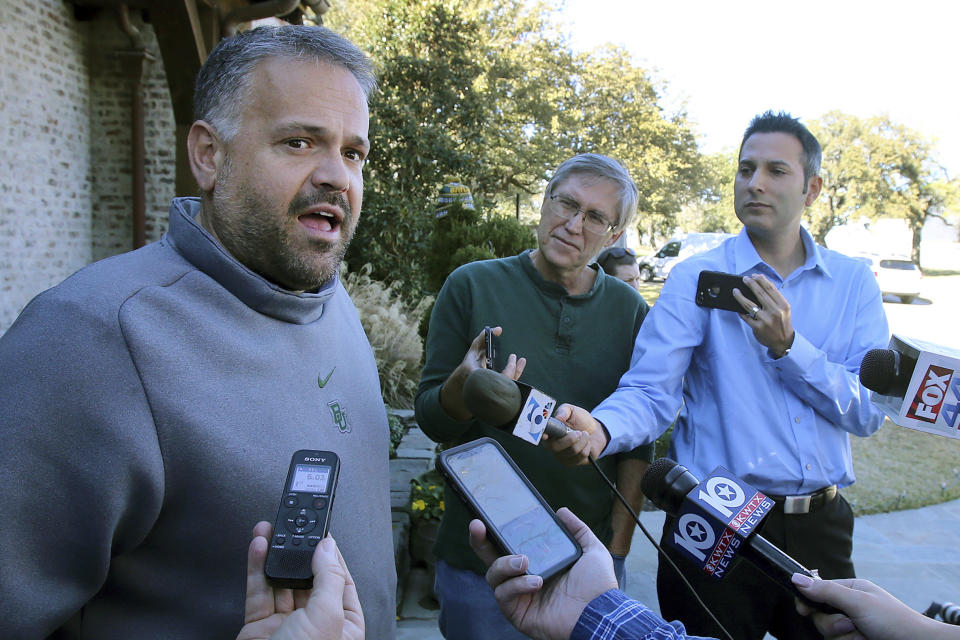 FILE - In this Jan. 7, 2020, file photo, former Baylor head football coach Matt Rhule speaks to reporters outside his home in Waco, Texas. In a normal year, new Carolina Panthers NFL football head coach Matt Rhule would have greeted many of the team's players for the first time with a handshake Monday for the start of the team's offseason workout program. But nothing is normal in the days of a global pandemic. (Jerry Larson/Waco Tribune-Herald via AP, File)