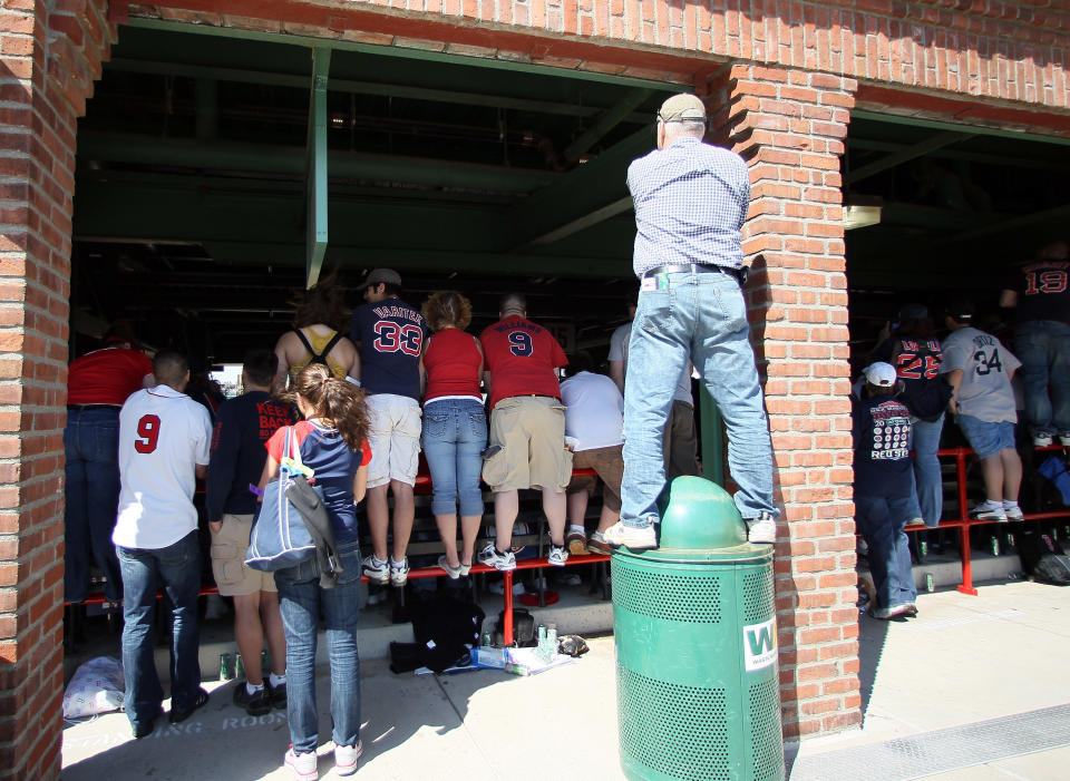 BOSTON, MA - APRIL 20: Standing room only fans try to get a good view of the 100 Year celebration ceremony before the game between the New York Yankees and the Boston Red Sox on April 20, 2012 at Fenway Park in Boston, Massachusetts. Today marks the 100 year anniversary of the ball park's opening. (Photo by Elsa/Getty Images)