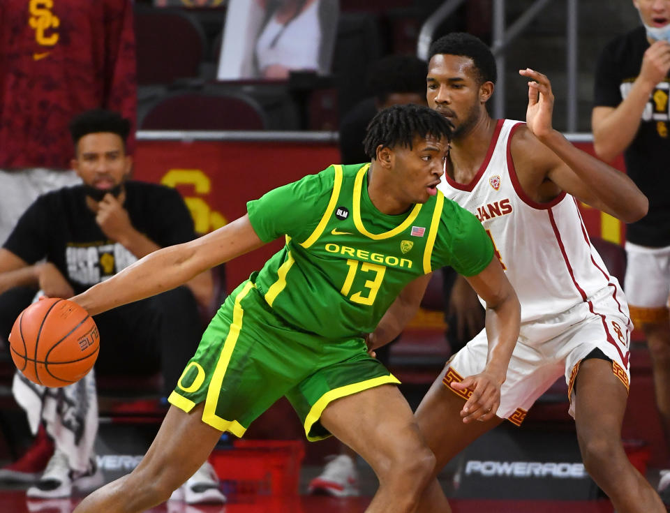 Feb 22, 2021; Los Angeles, California, USA; Oregon Ducks forward Chandler Lawson (13) is defended by USC Trojans forward Evan Mobley (4) as he drives to the basket in the first half of the game at Galen Center. Mandatory Credit: Jayne Kamin-Oncea-USA TODAY Sports