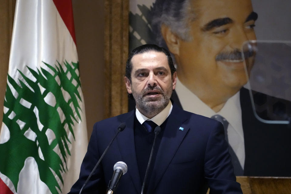 Former Lebanese Prime Minister Saad Hariri speaks during a press conference in front of a picture of his late father and former Prime Minister of Lebanon Rafic Hariri, at his house in downtown Beirut, Lebanon, Monday, Jan. 24, 2022. Hariri said Monday he is suspending his work in politics and will not run in May’s parliamentary elections. (AP Photo/Hussein Malla)