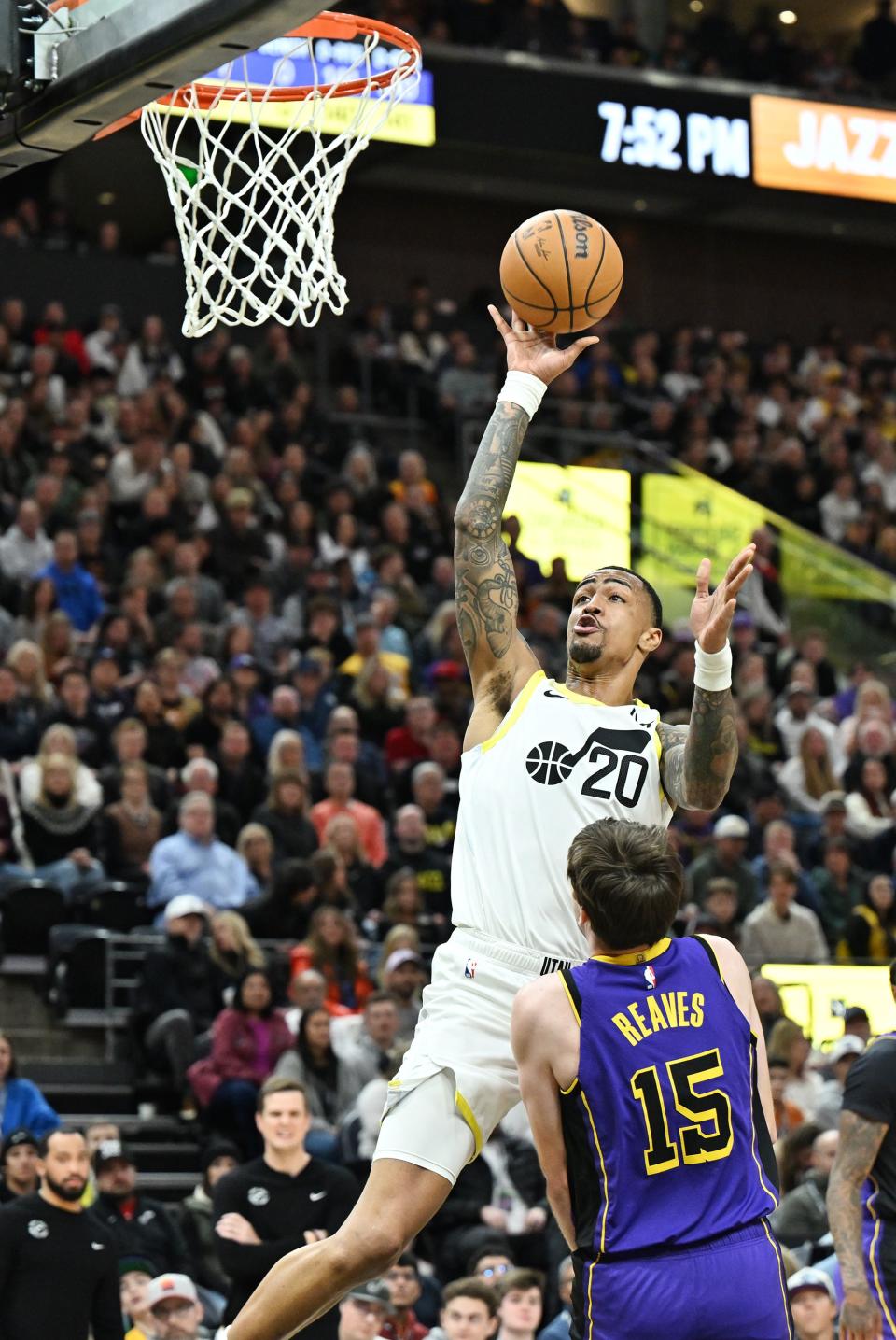 Utah Jazz forward John Collins (20) pushes up a shot over Los Angeles Lakers guard Austin Reaves (15) as Utah and Los Angeles play at the Delta Center in Salt Lake City on Saturday, Jan. 13, 2024. | Scott G Winterton, Deseret News