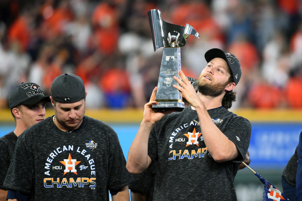 HOUSTON, TX - OCTOBER 19: Gerrit Cole #45 of the Houston Astros celebrates with the ALCS Trophy after winning the AL pennant with a 6-4 win in Game 6 of the ALCS against the New York Yankees at Minute Maid Park on Saturday, October 19, 2019 in Houston, Texas. (Photo by Cooper Neill/MLB Photos via Getty Images)