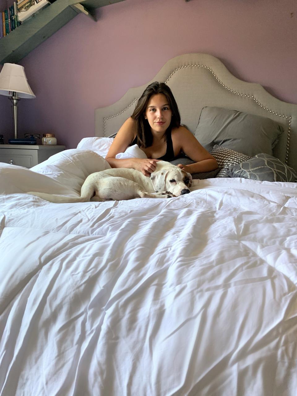 Writer Danielle Gonzalez and her pup, April, enjoying the Buffy Cloud Comforter. (Photo: <a href="https://www.instagram.com/wesleygonz_/" target="_blank">Wesley Gonzalez</a>)