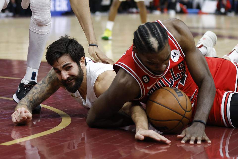 Cleveland Cavaliers guard Ricky Rubio, left, and Chicago Bulls forward Patrick Williams scramble for the ball during the second half of an NBA basketball game, Saturday, Feb. 11, 2023, in Cleveland. (AP Photo/Ron Schwane)