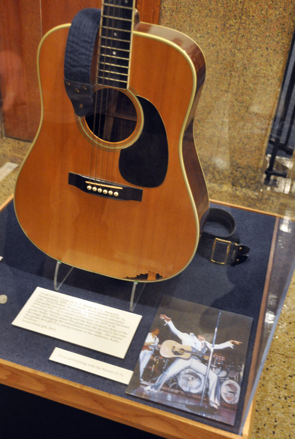 This April 22, 2013 photo shows a Martin D-35 guitar played by Elvis Presley during the final tour before his death in 1977 at the National Music Museum in Vermillion, S.D. The instrument was donated to the museum by Robert Johnson, a guitarist who played in the 1970s with Isaac Hayes and John Entwistle's Ox. Presley smashed the guitar after a string and the shoulder strap broke during a February 1977 show in St. Petersburg, Fla., and it was given that night to a woman in the audience. (AP Photo/Dirk Lammers)