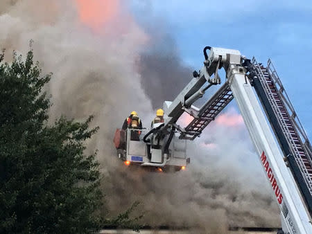 Firefighters battle a fire at a department store in Chingford, London, Britain August 23, 2017 in this still image obtained from social media. Jonathan Boyce via REUTERS