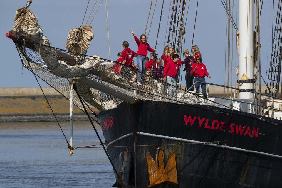 Image: Dutch teens cheer on their schooner Wylde Swan after sailing home from the Caribbean across the Atlantic when coronavirus lockdowns prevented them flying, in the port of Harlingen, northern Netherlands (Peter Dejong / AP)