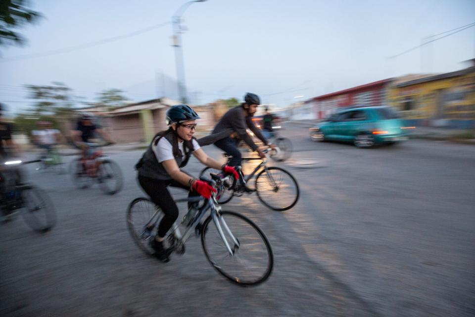 Melissa Acedo Rivera, rides with Bastards Border Cycling Club through the streets of Downtown Júarez on a warm night in April 2022.