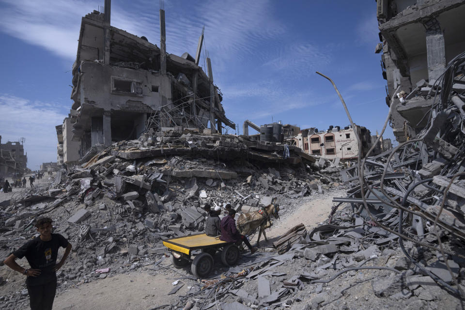 Palestinians find their home city unrecognizable in Khan Younis, southern Gaza Strip, April 8, 2024, as they filtered in to salvage what they could from the vast destruction left by Israeli troops who withdrew from Khan Younis a day earlier after months of fighting and bombardment. (AP Photo/Fatima Shbair)