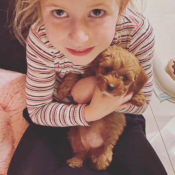 Sonia Kruger's daughter Maggie with a puppy