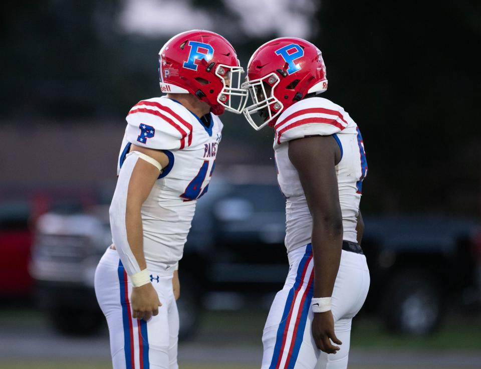 Jackson Ward (42) and Tylon Lee (6) celebrate after sacking quarterback John Nicholas (9) during the Pace vs West Florida football game at West Florida High School in Pensacola on Friday, Sept. 8, 2023.