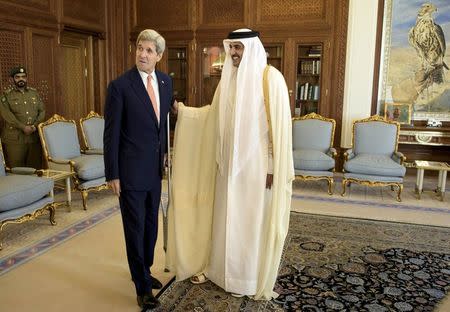 U.S. Secretary of State John Kerry (L) talks with Qatar's Emir Sheikh Tamim bin Hamad al-Thani before their meeting at the Diwan Palace in Doha, August 3, 2015. REUTERS/Brendan Smialowski/Pool