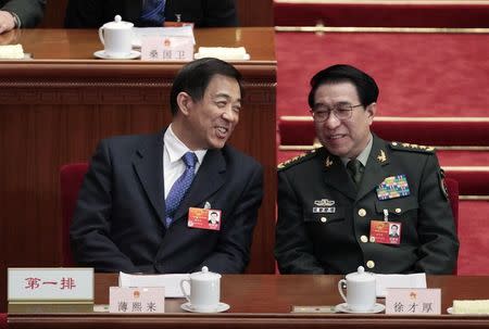 China's Chongqing Municipality Communist Party Secretary Bo Xilai (L) talks with Vice Chairman of China's Central Military Commission Xu Caihou (R) as they attend a plenary session of the National People's Congress (NPC) at the Great Hall of the People in Beijing, in this March 11, 2012 file photo. REUTERS/Jason Lee/Files