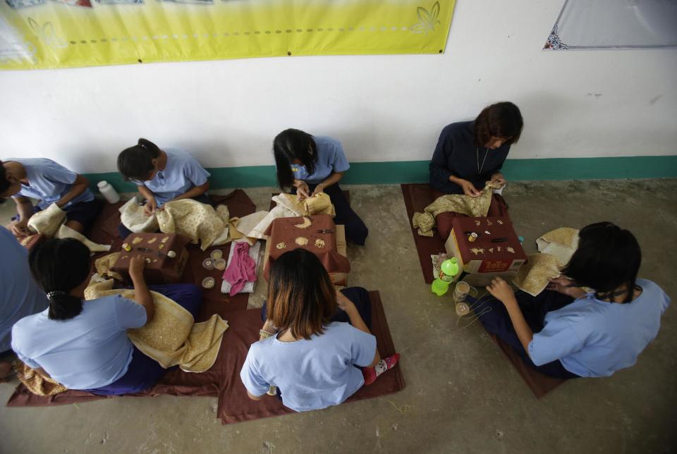 In this Jan. 6, 2017 photo, transgender inmates learn embroidery at Pattaya Remand Prison in Pattaya, Chonburi province, Thailand. The prison separates lesbian, gay, bisexual and transgender prisoners from other inmates, a little-known policy despite being in place nationwide since 1993, according to the Department of Corrections. (AP Photo/Sakchai Lalit)