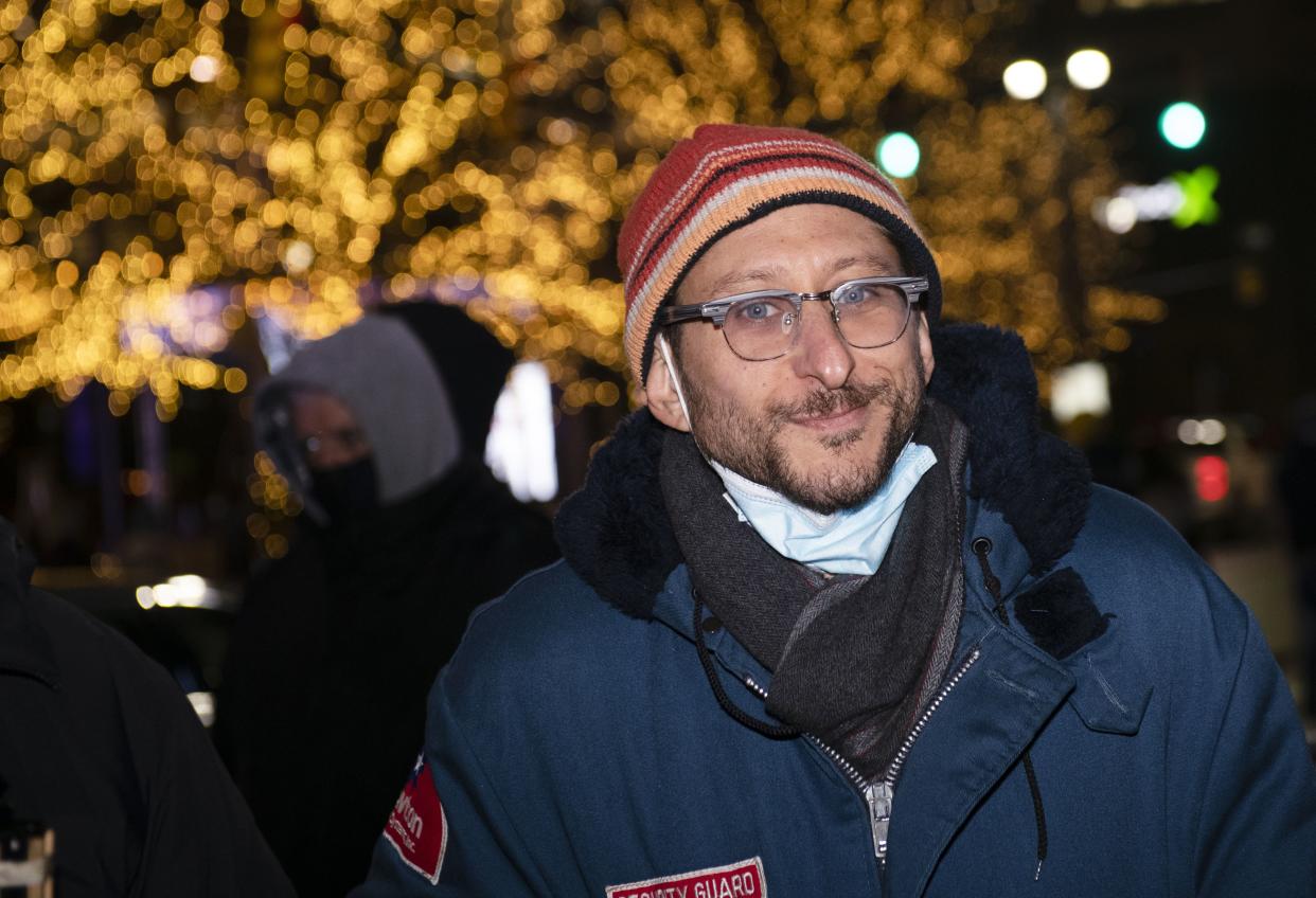 Honorary lamplighter Danny Fenster, an American journalist who was recently freed from prison in Myanmar and returned home, smiles while waiting to light the giant Menorah to officially begin Chanukah in Campus Martius Park Sunday, Nov. 28, in Detroit. 