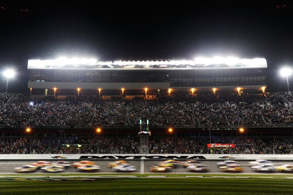 DAYTONA BEACH, FL - FEBRUARY 18: Martin Truex Jr., driver of the #56 NAPA Auto Parts Toyota and Jamie McMurray, driver of the #1 Bass Pro Shops/Tracker Boats Chevrolet, lead a group of cars at the start of the NASCAR Budweiser Shootout at Daytona International Speedway on February 18, 2012 in Daytona Beach, Florida. (Photo by John Harrelson/Getty Images for NASCAR)