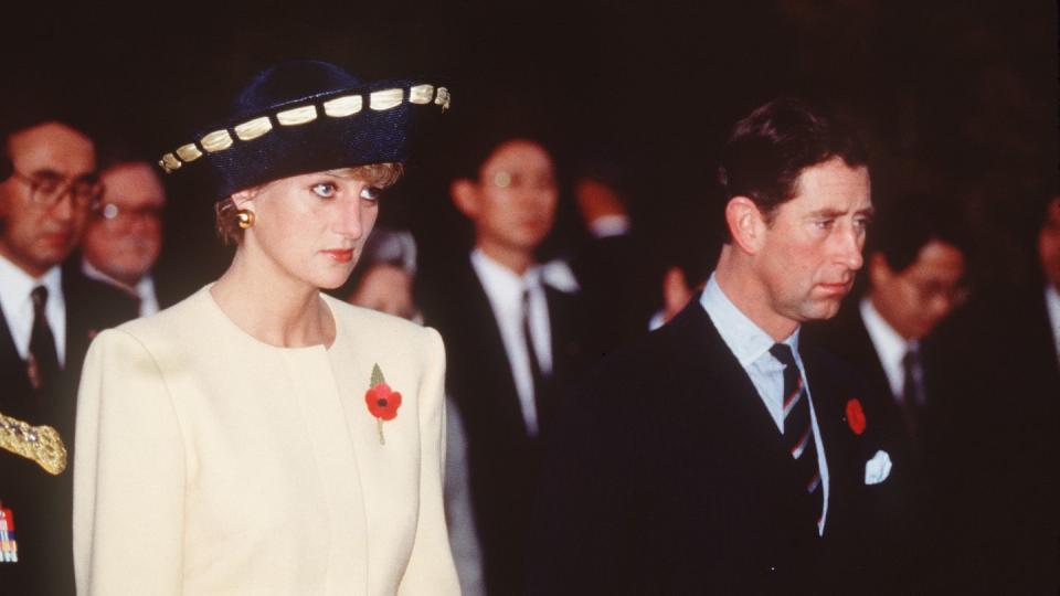 princess diana and prince charles look glum while walking next to each other