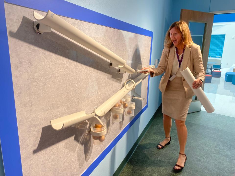 Gregory-Portland ISD Superintendent Michelle Cavazos tries out an activity Wednesday in a pre-K classroom at the district's Early Childhood Center. The new building will open for the 2024-25 school year.