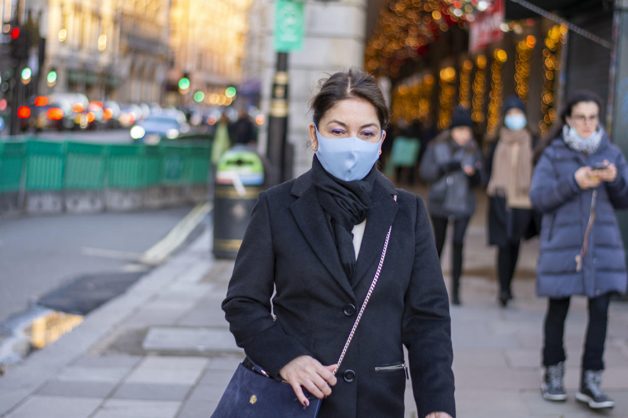  A lady wearing a face mask as preventive measure against the spread of covid 19 walks in Green Park. Under tier four restrictions, pubs and restaurants will close, as well as �non-essential� retail. (Photo by Pietro Recchia / SOPA Images/Sipa USA) 