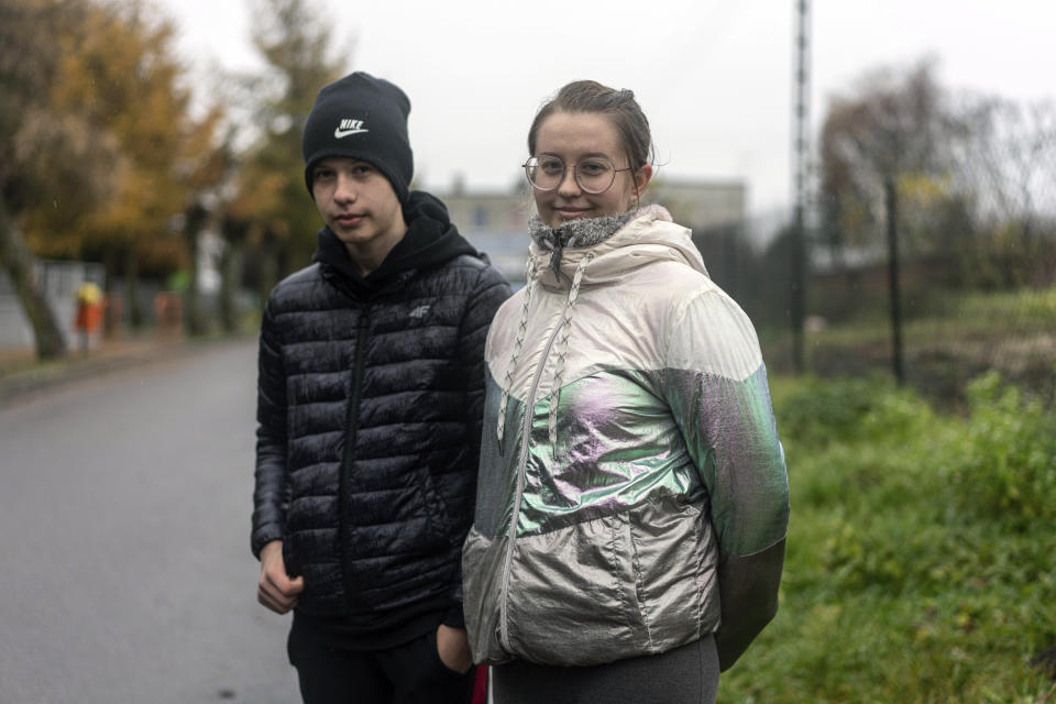 CORRECTS SURNAME TO KANCIR NOT CANCER - Kinga Kancir, 24, right, speaks to the Associated Press journalist near the place where a missile struck, killing two people in a farmland at the Polish village of Przewodow, near the border with Ukraine, Wednesday, Nov. 16, 2022. (AP Photo/Evgeniy Maloletka)