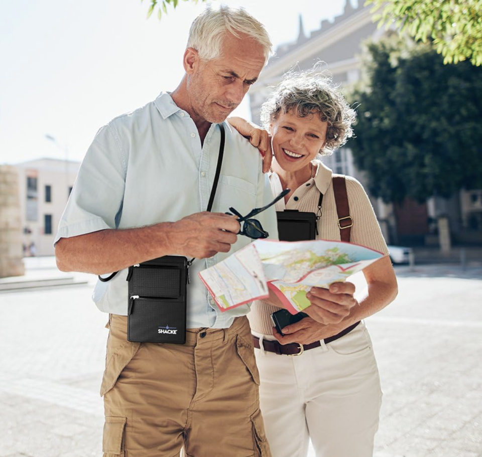 two people talking with black wallet around neck