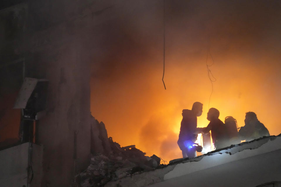 Firefighters try to extinguish the fire inside an apartment following a massive explosion in the southern suburb of Beirut, Lebanon, Tuesday, Jan. 2, 2024. The TV station of Lebanon's Hezbollah group says top Hamas official Saleh Arouri was killed Tuesday in an explosion in a southern Beirut suburb. (AP Photo/Hussein Malla)