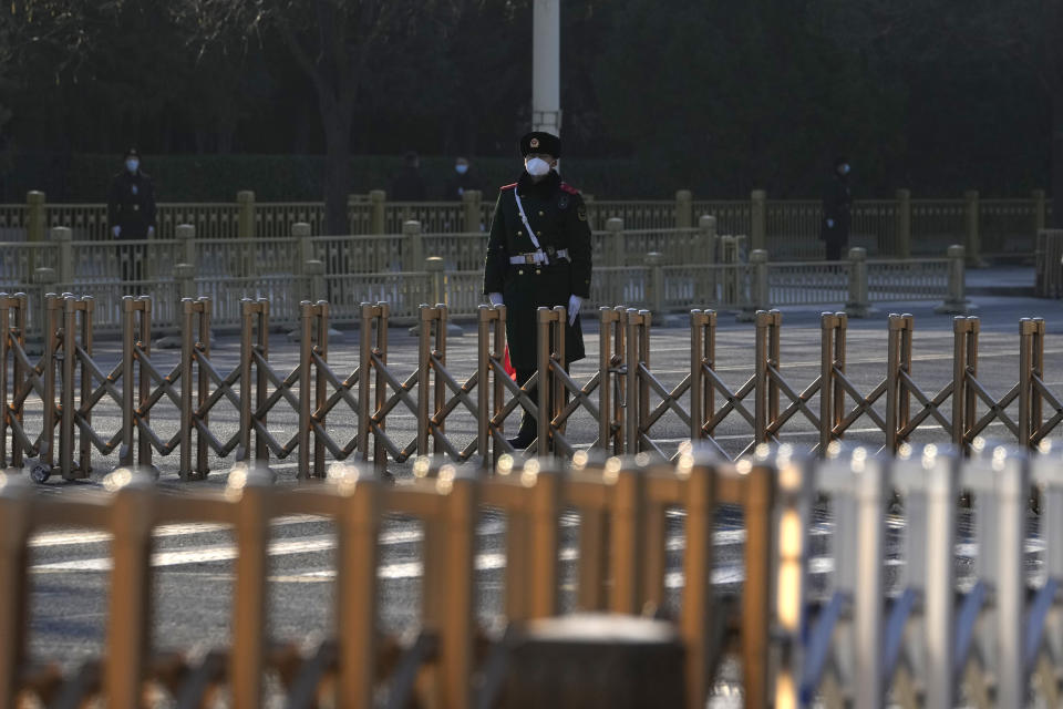 A Chinese paramilitary policeman guards a road leading to the Great Hall of the People where a memorial for the late former Chinese President Jiang Zemin is held in Beijing, Tuesday, Dec. 6, 2022. A formal memorial service for the late president is held Tuesday at the Great Hall of the People, the seat of the ceremonial legislature in the center of Beijing. (AP Photo/Ng Han Guan)