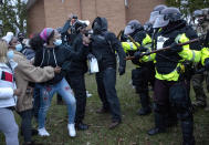 State Troopers pushed the crowd back near the Brooklyn Center Police Department during a No Justice No Peace rally at the Brooklyn Center Police Department, in Brooklyn Center, Minn., Monday, April 12, 2021, following the police shooting death of Daunte Wright. (Carlos Gonzalez/Star Tribune via AP)