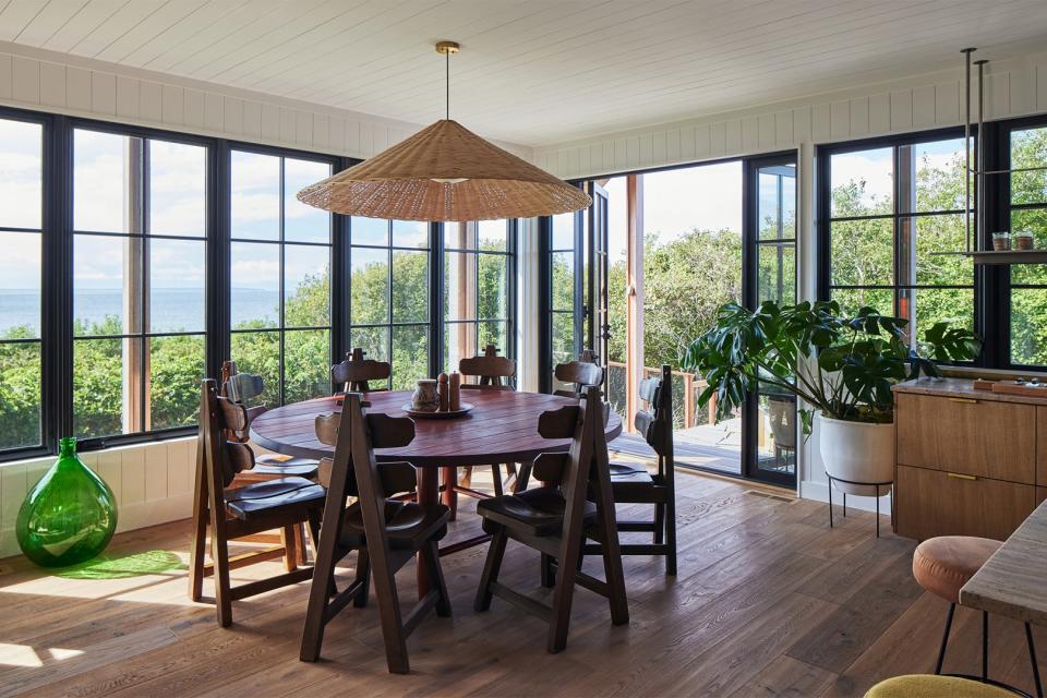 Dining room with round table and woven light fixtures