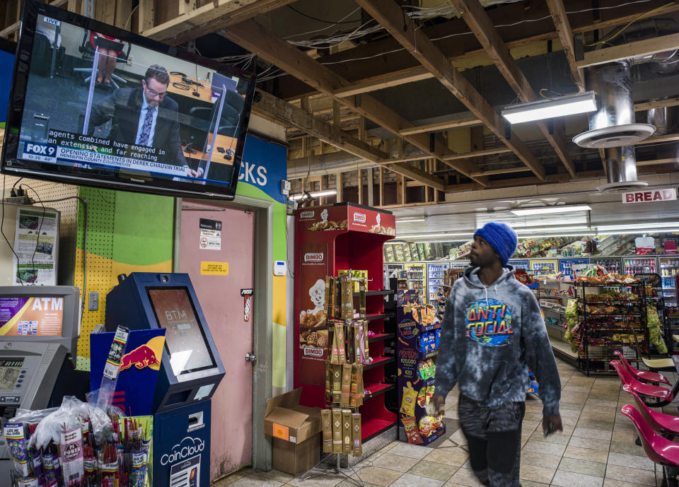 Roland Jackson looks up to a TV to check on the Derek Chauvin trial while getting some breakfast inside the Cup Foods at George Floyd Square in Minneapolis, Minn., on Monday, March 29, 2021. "I just want justice to be served," said Jackson. (Richard Tsong-Taatarii/Star Tribune via AP)