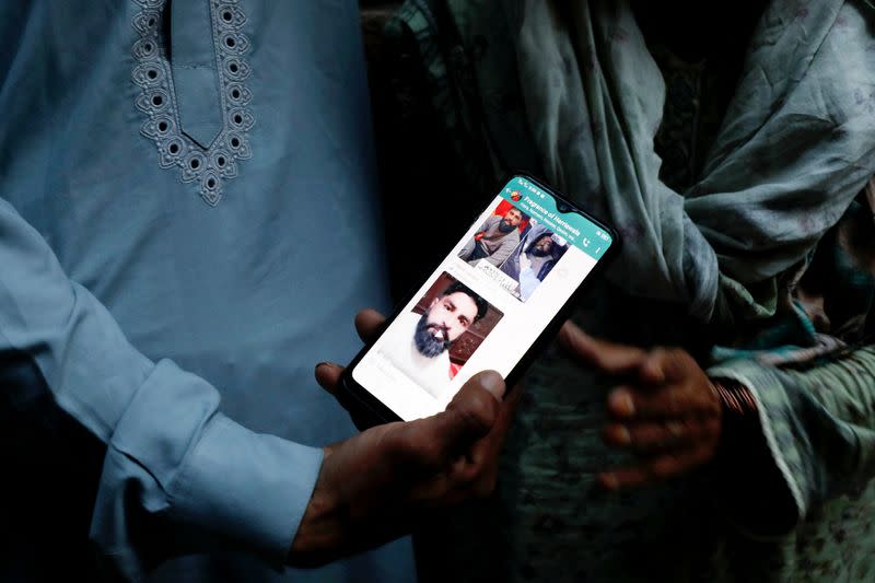 A family member shows a picture of Muhammad Nadeem, in Hariyawala town in Gujrat