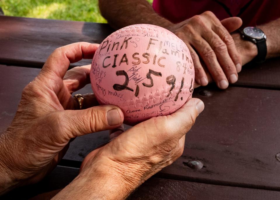 Jeff Gorenc holds a pink softball from the original Pink Flamingo Classic in 1984 with the amount of money the event raised written in marker. All 39 pink softballs from each year of the tournament will be on display in a tent for this year's 40th anniversary.