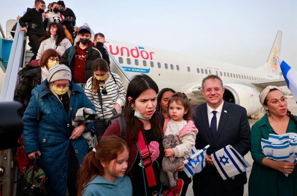 Passengers disembark from an airplane carrying Jewish immigrants fleeing Russia's war in Ukraine, upon arrival in Israel's Ben Gurion Airport in Lod near Tel Aviv, on March 6, 2022. (Photo by Menahem Kahana/AFP via Getty Images)