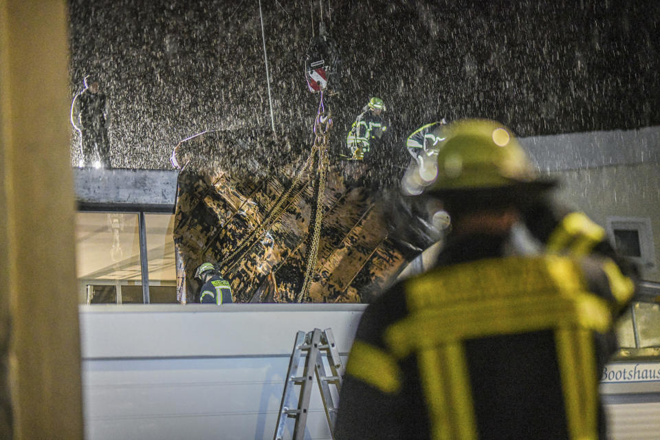 Firefighters secure part of the roof of their fire station with a crane at the fire station in Plüderhausen, east of Stuttgart, Germany Friday, Dec. 22, 2023 due to a storm. (Jason Tschepljakow/dpa via AP)