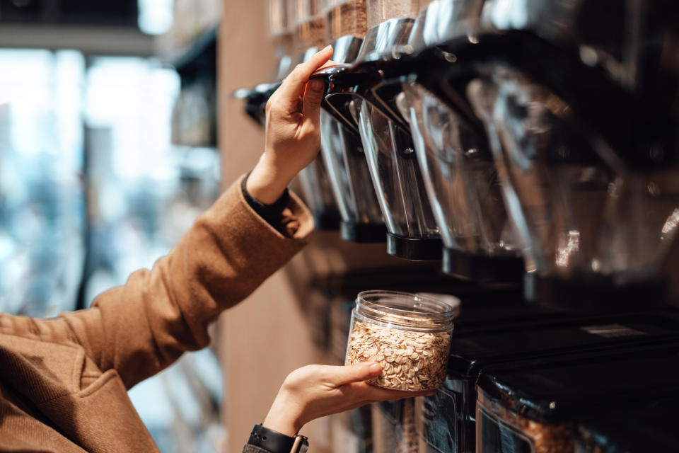 A woman buying oats at the market.