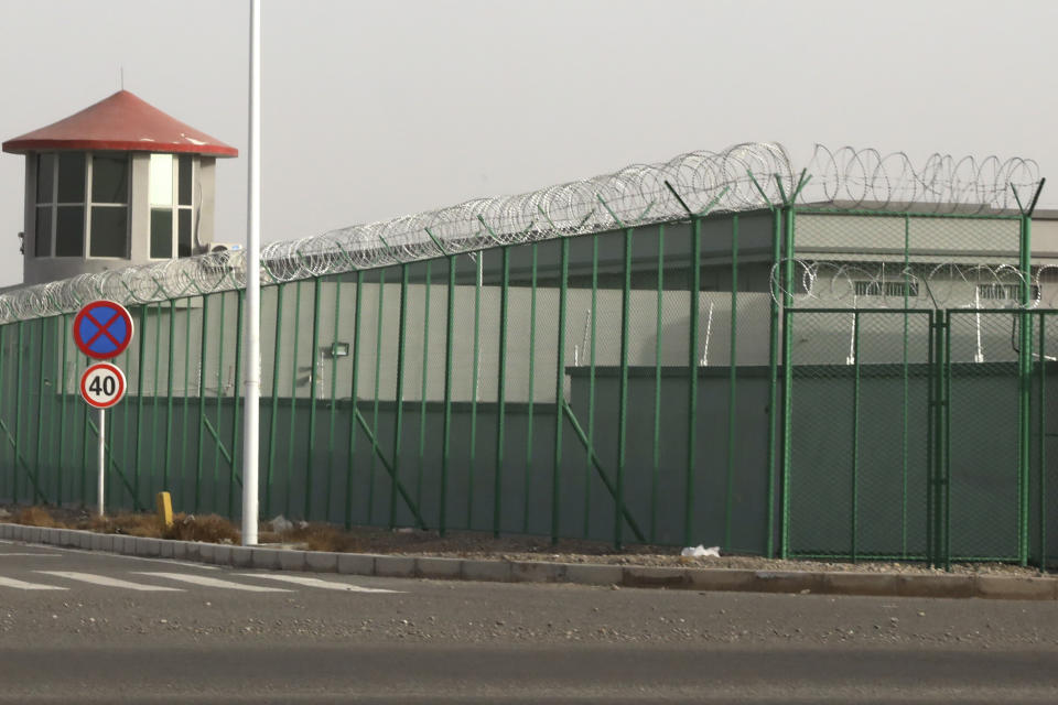 FILE - In this Monday, Dec. 3, 2018, file photo, a guard tower and barbed wire fences surround an internment facility in the Kunshan Industrial Park in Artux in western China's Xinjiang Uyghur Autonomous Region. A spokesperson for the Xinjiang region called accusations of genocide "totally groundless" as the British parliament approved a motion Thursday, April 22, 2021 that said China's policies amounted to genocide and crimes against humanity. (AP Photo/Ng Han Guan, File)