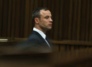 Oscar Pistorius listens to evidence being given in court in Pretoria, South Africa, Tuesday, April 15, 2014 after questioning by state prosecutor Gerrie Nel, had earlier finished. Pistorius is charged with the murder of his girlfriend Reeva Steenkamp, on Valentines Day in 2013. (AP Photo/Alon Skuy, Pool)