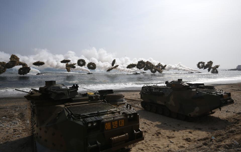 Amphibious assault vehicles of the South Korean Marine Corps throw smoke bombs as they move to land on shore during a U.S.-South Korea joint landing operation drill in Pohang March 31, 2014. The drill is part of the two countries' annual military training called Foal Eagle, which began on February 24 and runs until April 18. (REUTERS/Kim Hong-Ji)