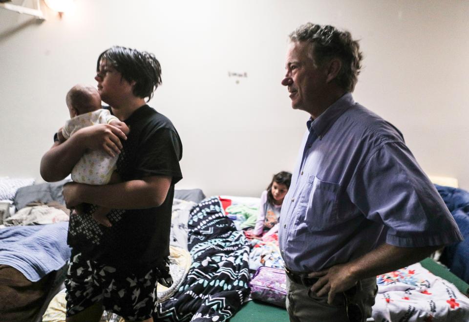 Isaac Aguirre holds his cousin Jerome Cotton as Kentucky Sen. Rand Paul makes a visit at Gospel Light Baptist Church in Hazard Tuesday morning. Isaac and the baby were airlifted from their flooded home.
