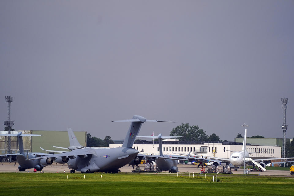 Planes stand after the arrival of the first flight of people evacuated from Kabul, at RAF Brize Norton, England, Monday Aug. 16, 2021. International nations have scrambled to evacuate their diplomats, local allies and their families from Kabul, following the fall of the Western-backed Afghanistan government to the Taliban. (Steve Parsons/PA via AP)
