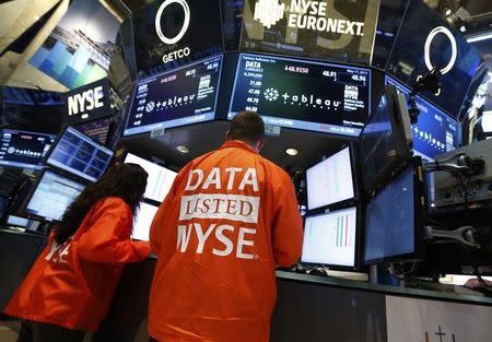 Getco Securities specialist traders work at the booth that trades Tableau Software on the floor of the New York Stock Exchange, in this May 17, 2013 file photo. REUTERS/Brendan McDermid