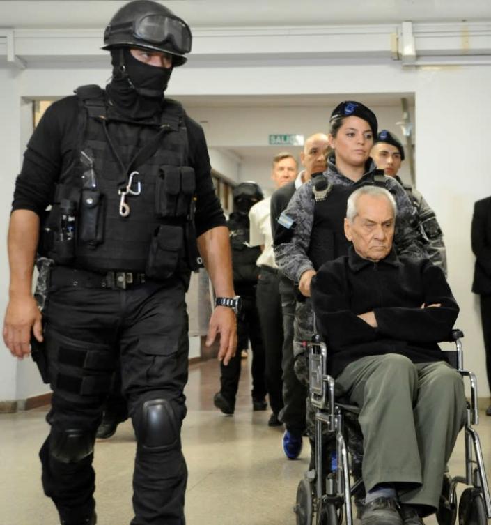 Italian Catholic priest Nicola Corradi being wheeled into court ahead of his sentencing Monday (AFP Photo/Andres Larrovere)