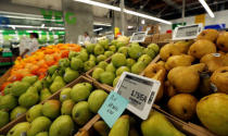 Prices of pears are displayed on digital price tags at a 365 by Whole Foods Market grocery store ahead of its opening day in Los Angeles, U.S., May 24, 2016. REUTERS/Mario Anzuoni