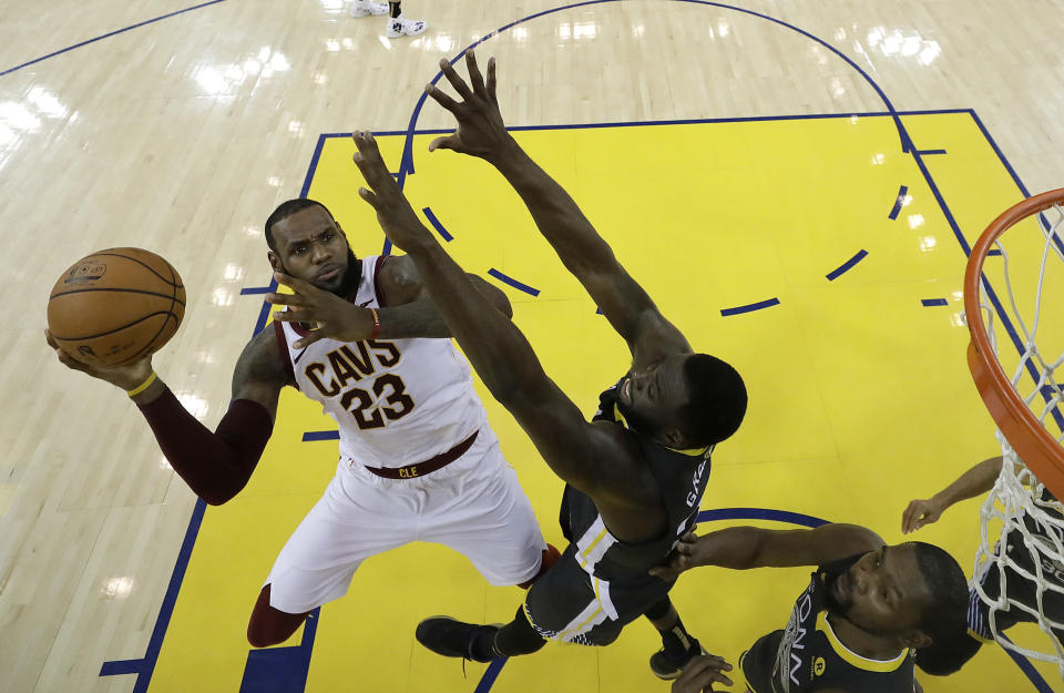 Draymond Green and Kevin Durant wait for LeBron James at the basket in Game 2 on Sunday night. (AP)