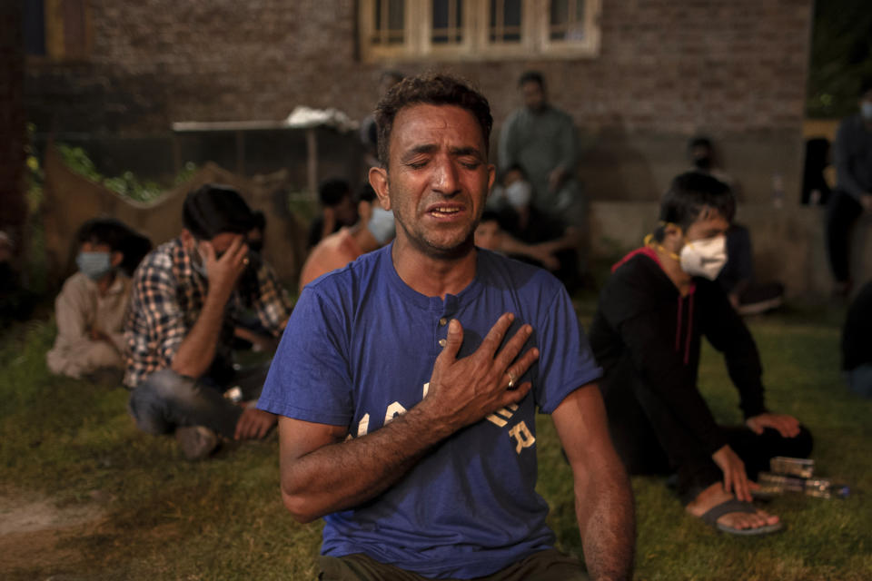 A Kashmiri Shiite Muslim mourns as he beats his chest with others to commemorate Muharram inside the lawn of a residential house in Srinagar Indian controlled Kashmir, Friday, Aug. 21, 2020. Observing the Muslim month of Muharram, which marks the martyrdom of the Prophet Muhammad’s grandson in the battle of Karbala, is an article of faith. But as the coronavirus spreads in Indian-controlled Kashmir, Shiite Muslims prefer to commemorate the holy days inside their home following the advice of religious scholars and health experts in the disputed region’s main city. (AP Photo/Dar Yasin)