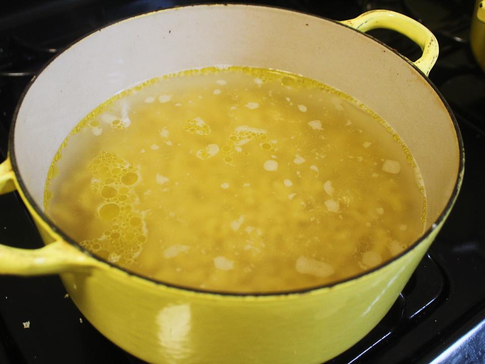 macaroni boiling in a yellow pot